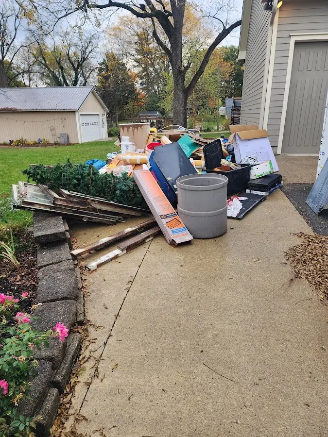 Dumpster being loaded with debris for Roofing Dumpster Rental in Kingsford
